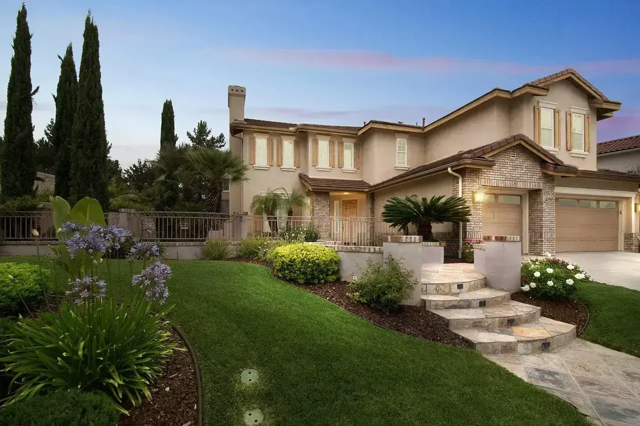 California home with a tile roof, stucco exterior and landscaped garden