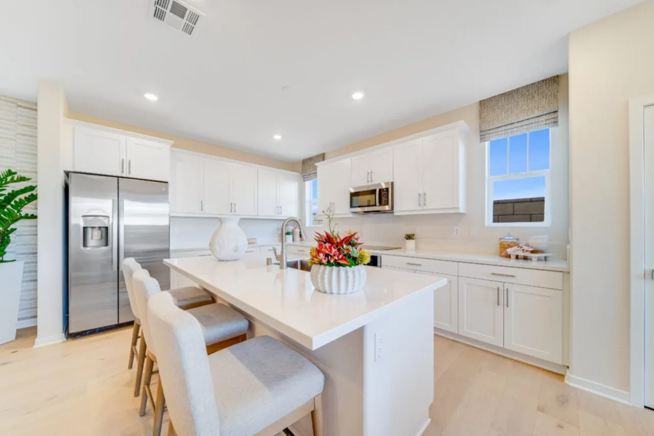 Bright kitchen with white cabinets and a large island