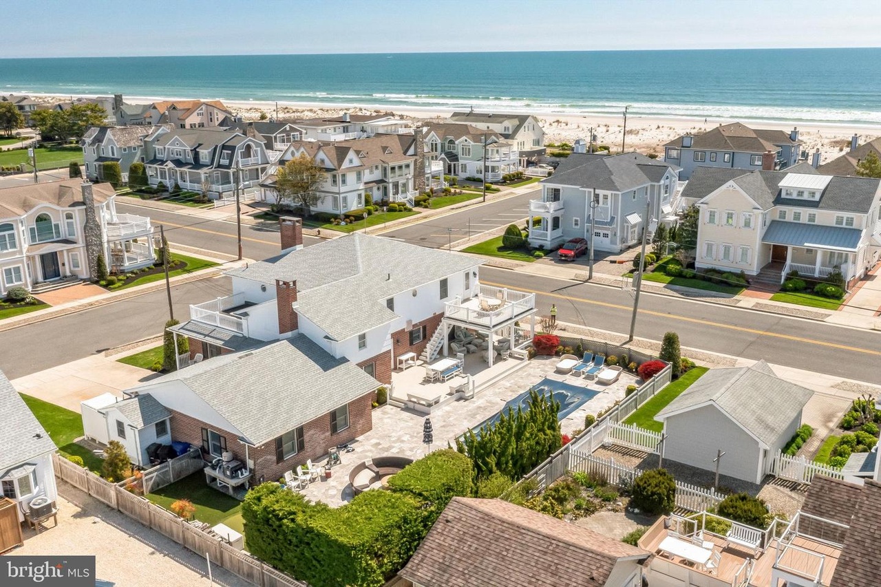 Aerial view of 9301 1st Avenue in Stone Harbor, with its pool and the ocean nearby.
