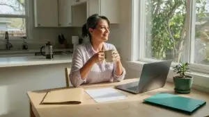 title search cost: a seller reviewing her closing paperwork at a sunlit kitchen table
